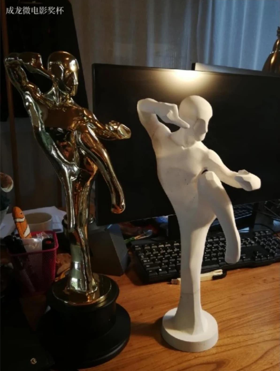 Figure and model of the Jackie Chan Microfilm Trophy